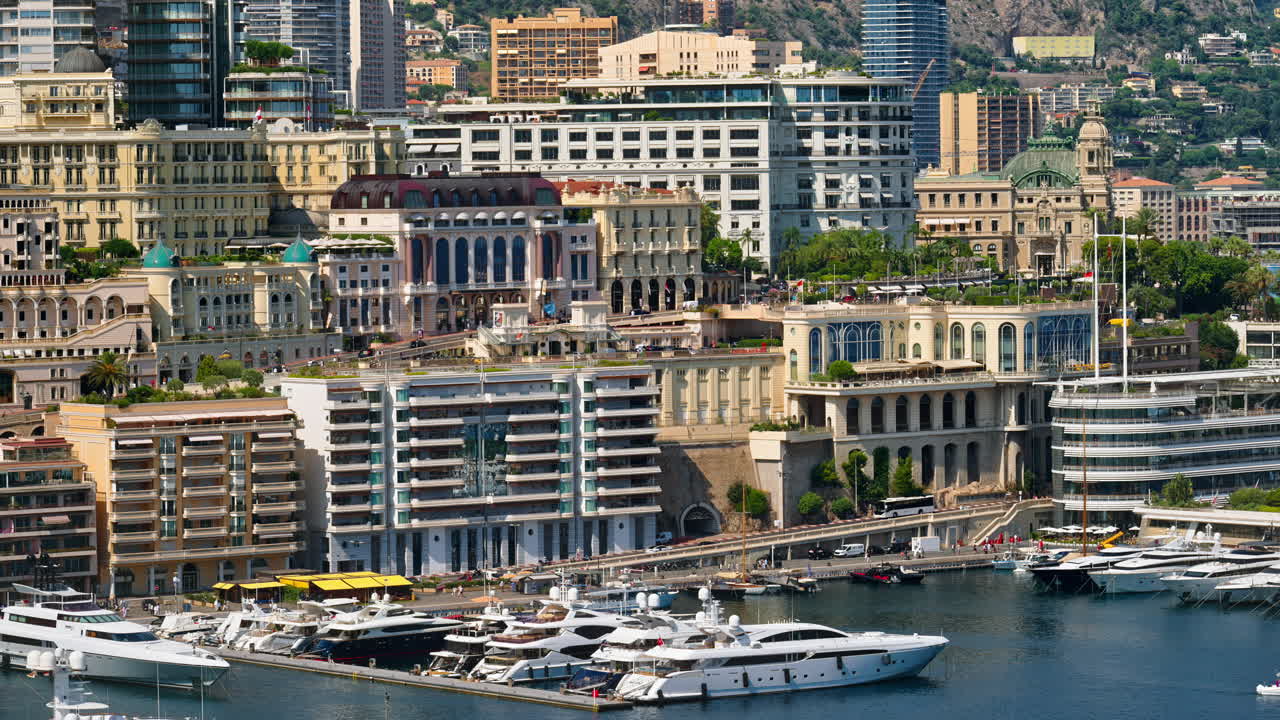 View of boats docked in the Monaco Marina with the skyline of the city on the background