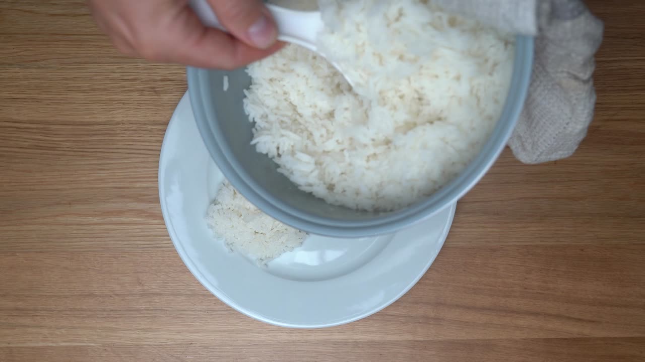 el arroz recién cocido del cocinero de arroz se sirve en un plato