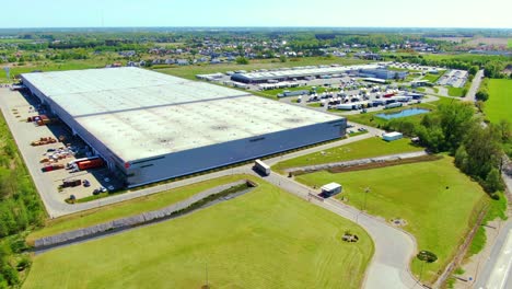 aerial view of warehouse storages or industrial factory or logistics center from above. top view of industrial buildings and trucks