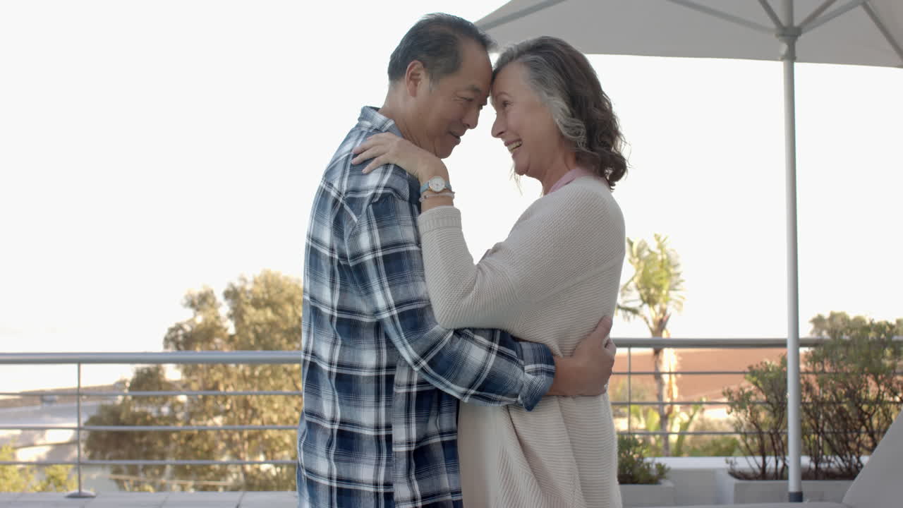 Dancing together, senior couple enjoying outdoor time on vacation