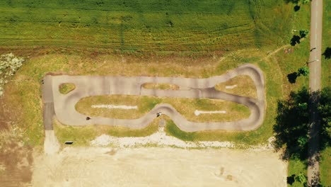 Aerial-view-of-people-racing-on-a-bicycle-pump-track-in-Spisska-Bela,-Slovakia