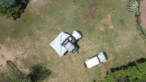 two jeeps camping in a field