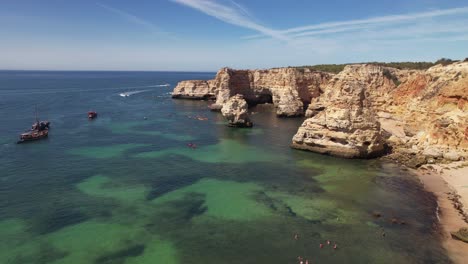 Flying-over-Praia-Da-Marinha--in-Algarve,-Portugal