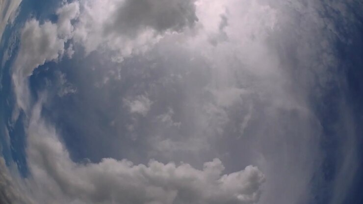 Blue sky and layer of clouds moving about in a fine sunny afternoon