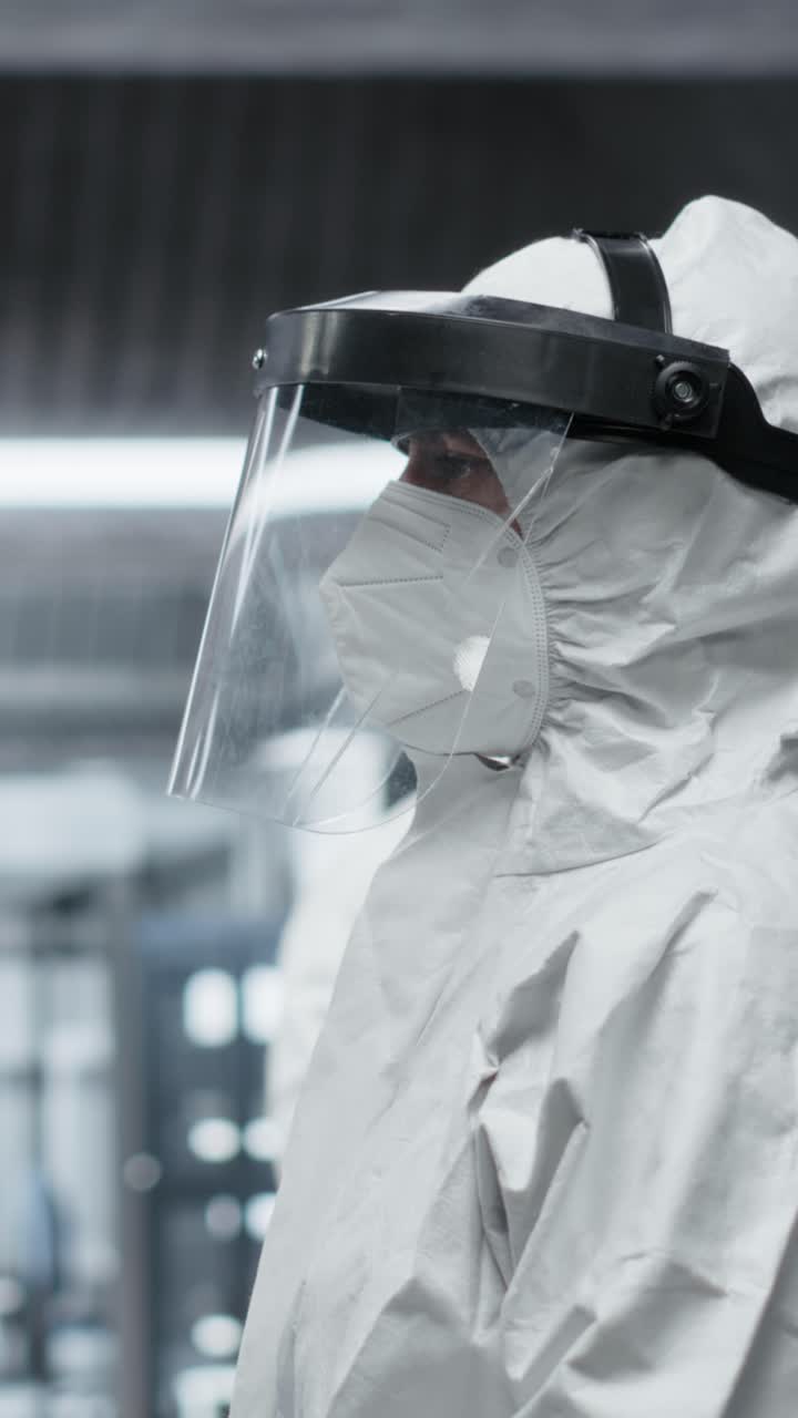 Vertical Video Researchers in biocontainment lab conduct experiments on viral pathogens