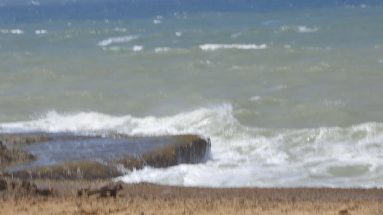 Waves crashing on desert rocks on the colombian peninsula near Guajira, Colombia.