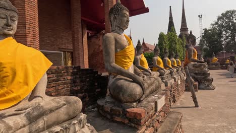 a serene walk past buddha statues in ruins.