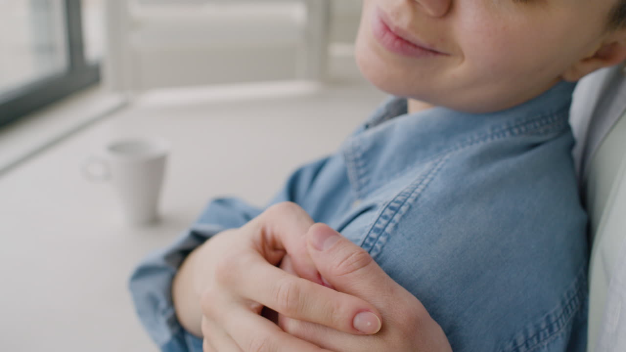 Close Up Of A Loving Man Tenderly Hugging Woman From The Back While She Gently Touching His Hand