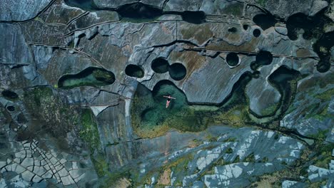 figure 8 pool, australia, drone ascending shot, girl floating in pool