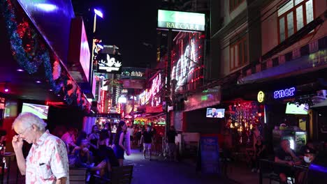 crowded street with neon lights and people