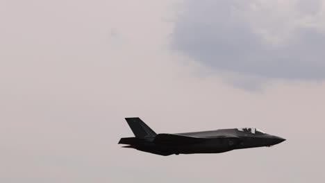 a fighter jet executes dynamic aerobatic maneuvers against a cloudy sky at the avalon airshow in geelong, australia