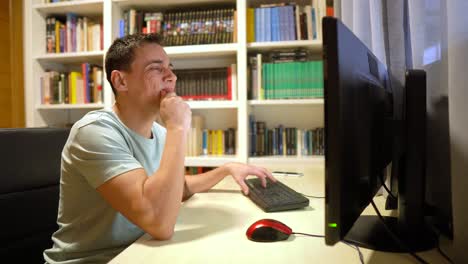 man reacting to computer screen with various emotions