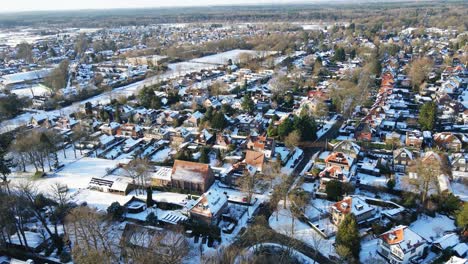 beautiful aerial of a wealthy suburban town on a sunny winter day