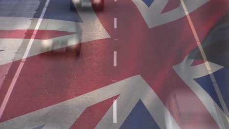 union jack flag waving over timelapse of cars driving on road