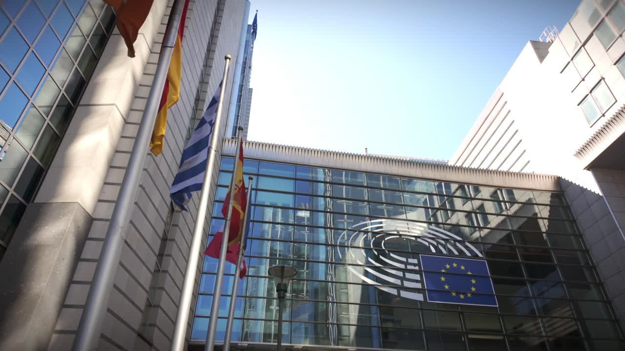 Flags of EU nations flying outside European Parliament in Brussels