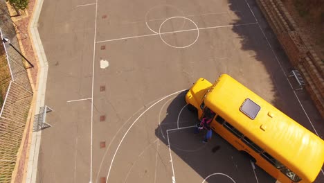 teacher giving high to kids while entering in bus