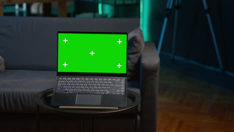 african american freelancer laying on the couch with music next to mockup display on pc, feeling happy with flexible work schedule at home. young adult uses his tablet relaxing on sofa. camera a.