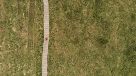 Hiker-walking-on-a-wooden-path