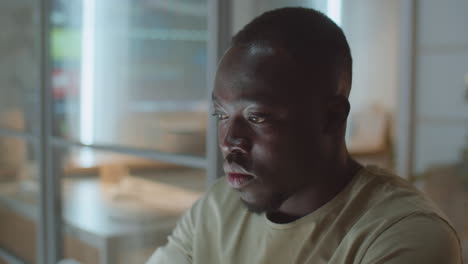 African American Man Working in Office at Night