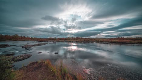 As-the-sun-sets-and-darkness-takes-over-the-landscape,-stormy-clouds-move-swiftly-through-the-skies