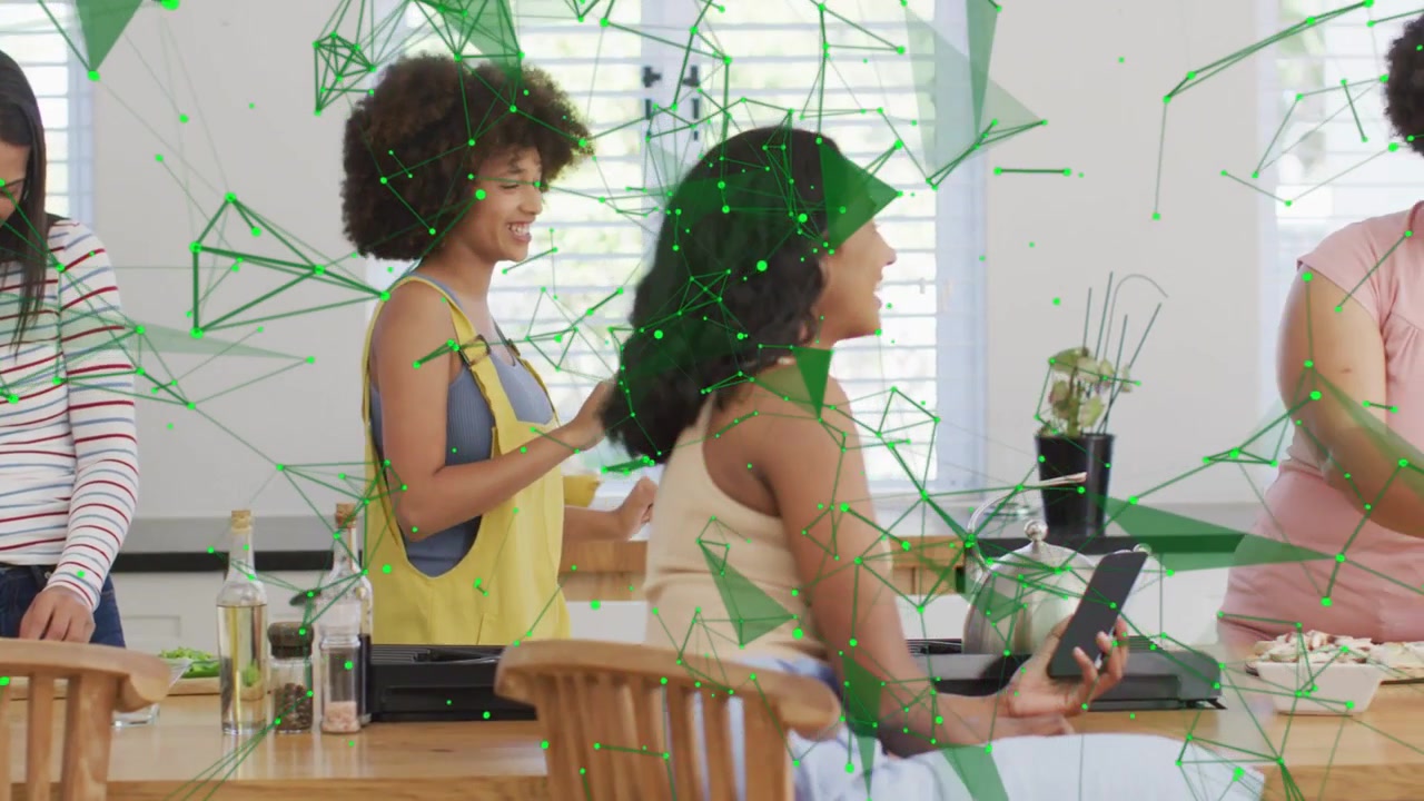 3 women cooking at island, tablet guiding recipe, pink joining, green web animating over tablet