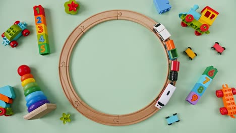 childish toy wooden railway. toy train travel along the ring railway. child's educational toys. top view. copy space