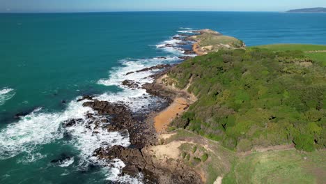 Katiki-point-scenic-coastal,-red-sand-beaches-and-rocky-cliffs,-native-vegetation-and-endless-ocean