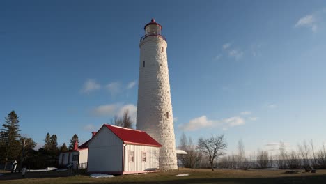 fast-moving clouds pass a great lakes lighthouse