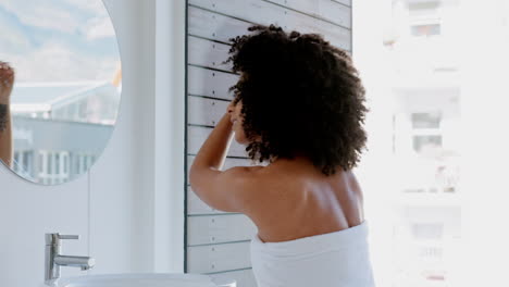 Black-woman,-afro-and-hair-care-in-house-bathroom