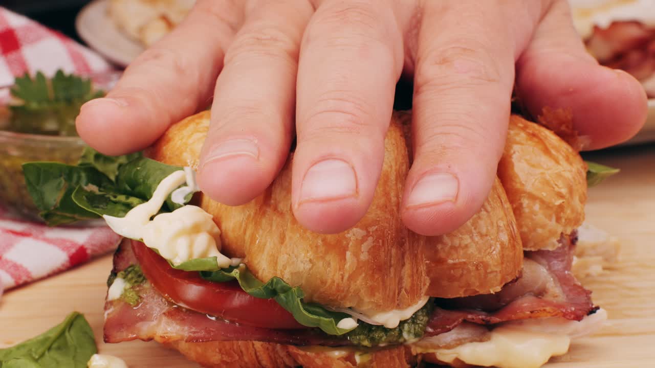 Croissant with jamon ham, Salmon, in Modern Cafe, Top View of Healthy Breakfast in Cafe. English breakfast: fried egg, bacon toast on sandwich.