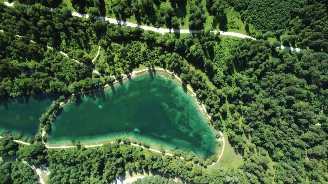 Aerial View of a Mountain Lake Surrounded by Lush Forest
