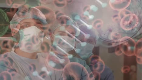 Animation-of-dna-strand-covid-19-cells-over-diverse-surgeons-wearing-face-masks-in-operating-theatre