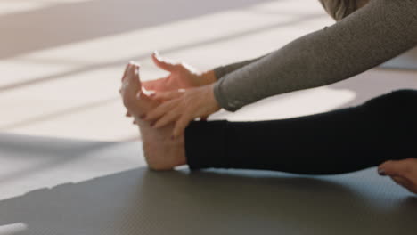 yoga class beautiful old woman exercising healthy meditation practice head to knee forward bend pose enjoying group physical fitness workout in studio