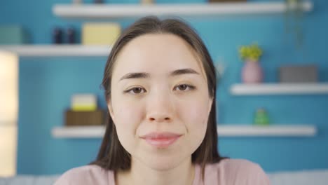 Close-up-portrait-of-young-Asian-woman-listening-to-news-and-announcements.