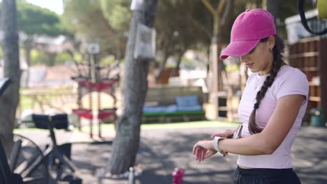 young woman checking phone outside