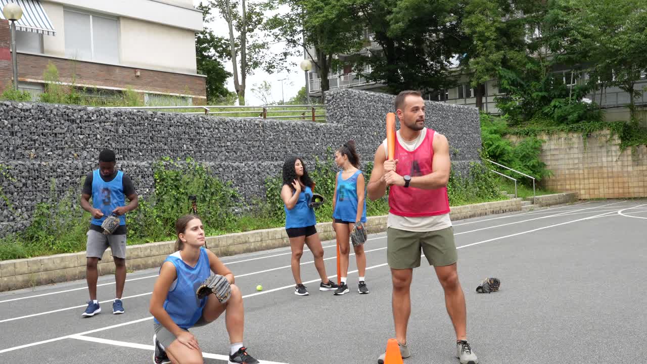 Group of people playing baseball outdoors