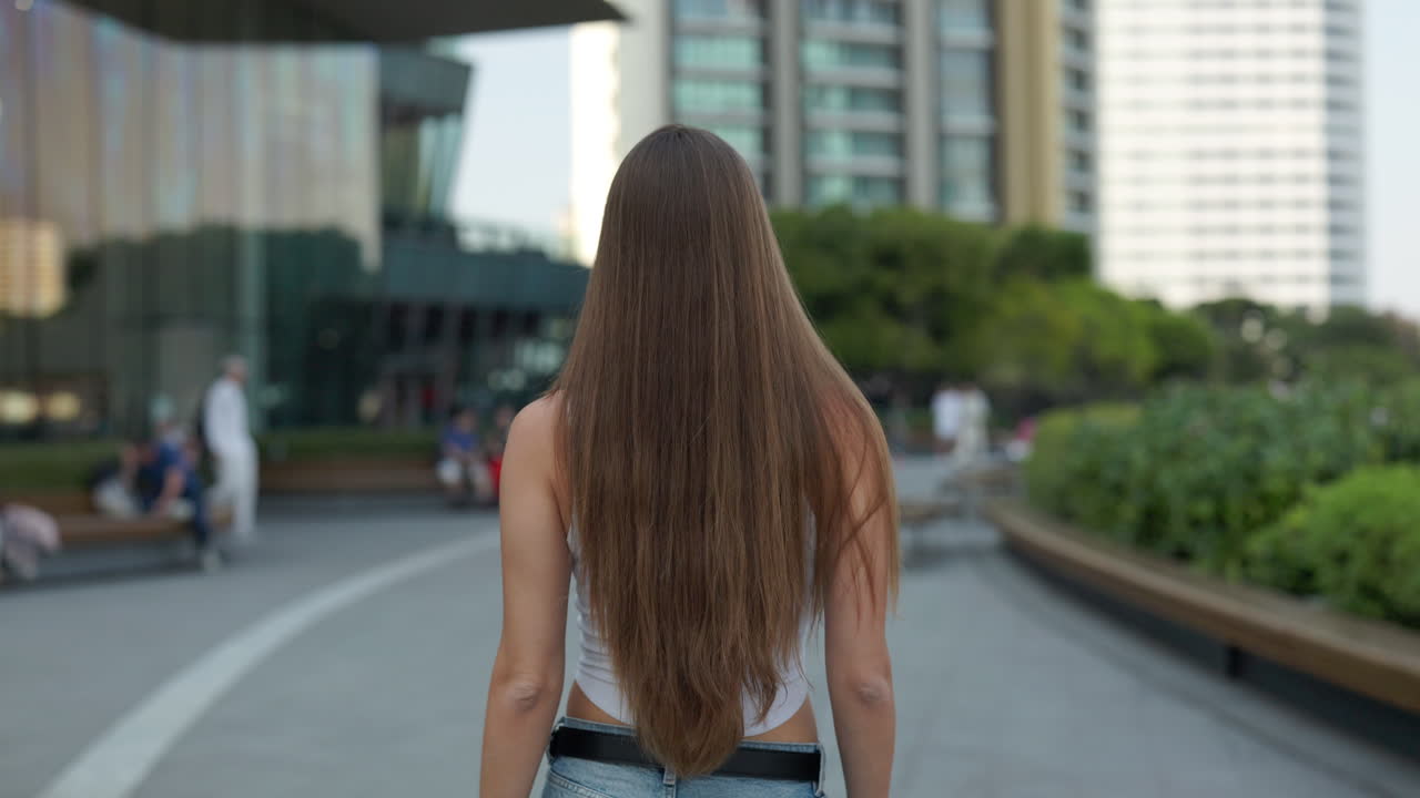 Woman with long hair walking in the city