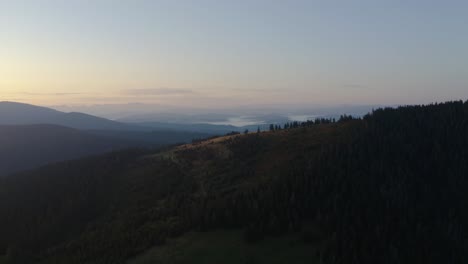 drone reveal of foggy lowland during sunrise