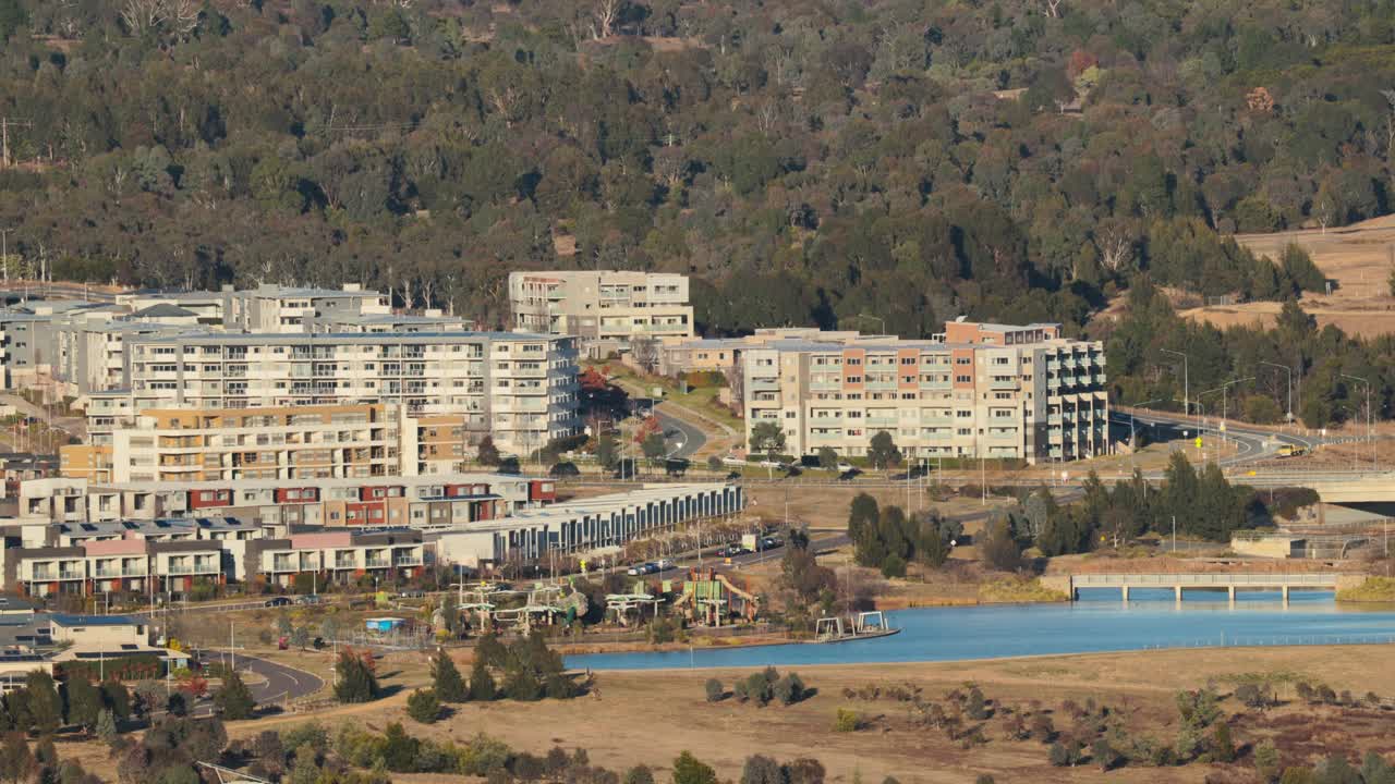 Slow zoom reveals a Canberra neighborhood with modern apartments, green spaces, and active development