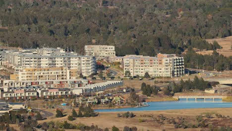 slow zoom reveals a canberra neighborhood with modern apartments, green spaces, and active development