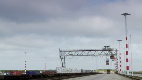 cargo operations at rotterdam port on a cloudy day with shipping containers