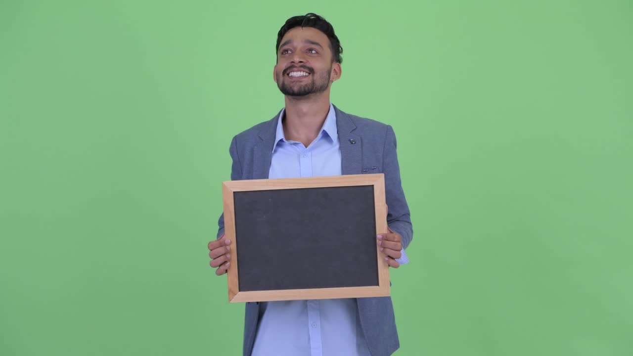 Young handsome bearded Persian businessman in suit