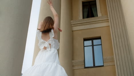 woman in a white dress posing in front of an ancient building
