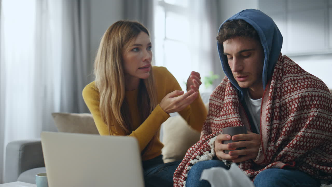 Ill couple medical consultation using laptop at home closeup. Man talking online
