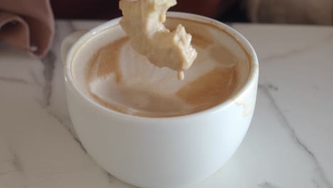 close up of a cup of coffee with latte art