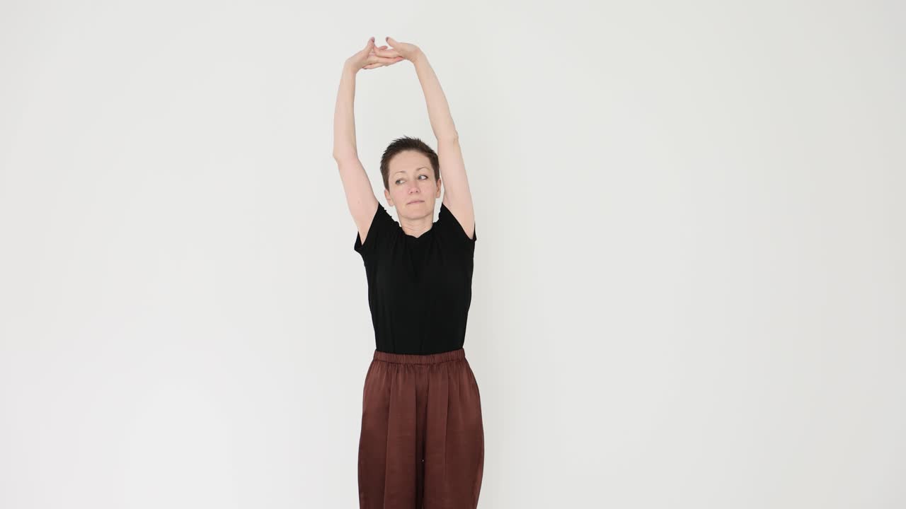 Woman Performing Side Bend and Overhead Arm Stretches