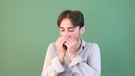 man coughing green background