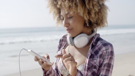 girl on beach listening to music