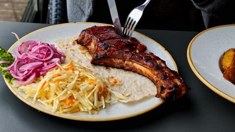 Plated-pork-chop-coleslaw-barbecued-on-the-rib-bone