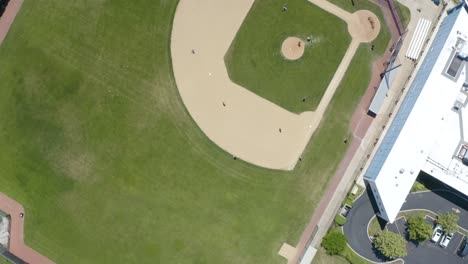 top down aerial view of people playing baseball game in summer